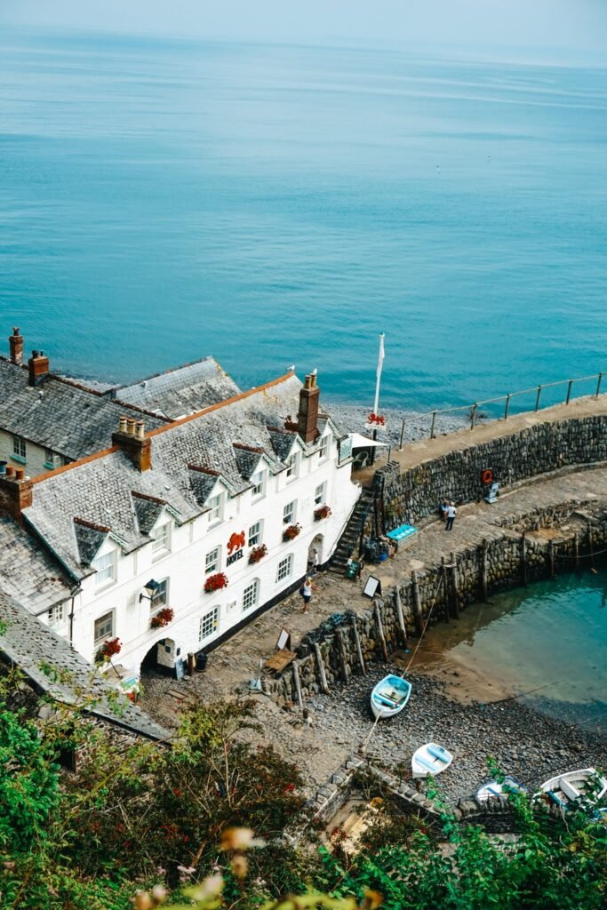Blue waters surround the harbour around red lion clovelly