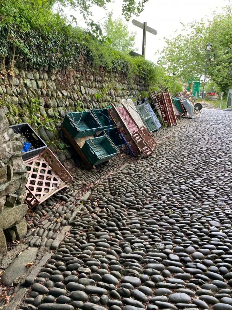 sledges stacked up again the wall on cobbled street