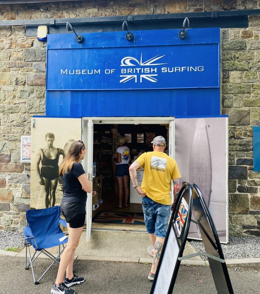 Image of the entrance to the museum. there are two people walking into the building
